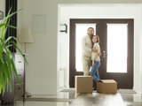 Ungt par står innan för dörren till sin nya bostadsrätt