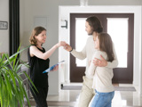 Kvinna lämnar över nycklar till par som ska hyra lägenhet i andrahand