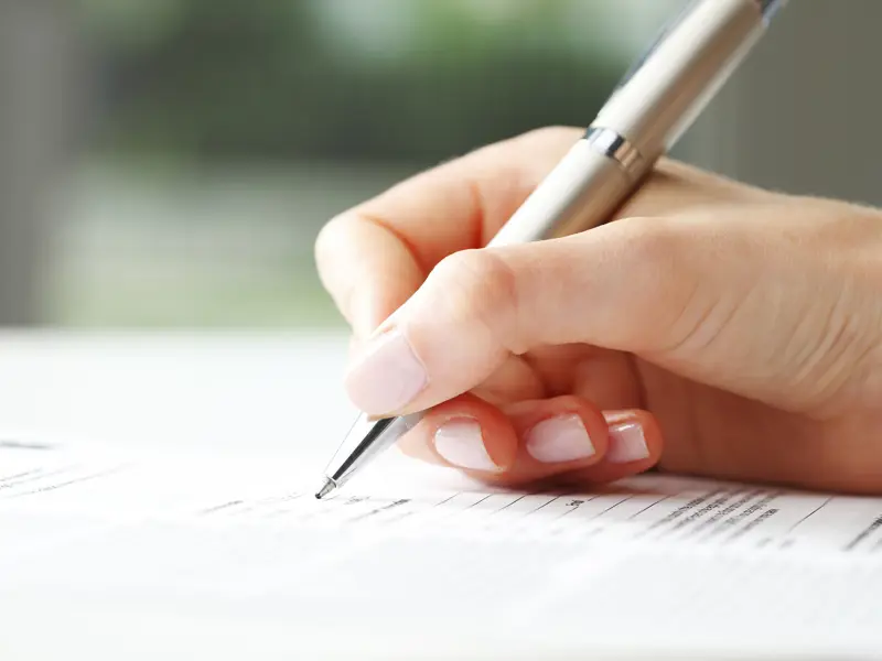 Hand skriver med en bläckpenna